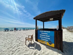 A beachside kiosk with a sign advertising chair rentals, parasailing, banana boat, beach photos, and bonfires. - Master on Gulf & close to Everything & Free round of Golf & Activities Daily! (Panama City Beach)