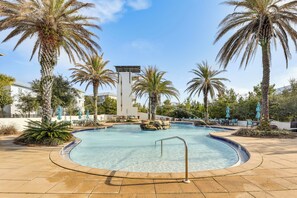 A pool surrounded by palm trees and lounge chairs, with a building in the background. - 1 Mi to Blue Mtn Beach! 30A Getaway w/ Golf Cart (Santa Rosa Beach)