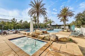 A pool area with lounge chairs, palm trees, and a hot tub. - 1 Mi to Blue Mtn Beach! 30A Getaway w/ Golf Cart (Santa Rosa Beach)