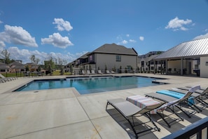 A swimming pool with lounge chairs and a covered area, surrounded by modern buildings. - 2 Mi to Dtwn! Newly Built Oxford Retreat w/ Porch (Oxford)