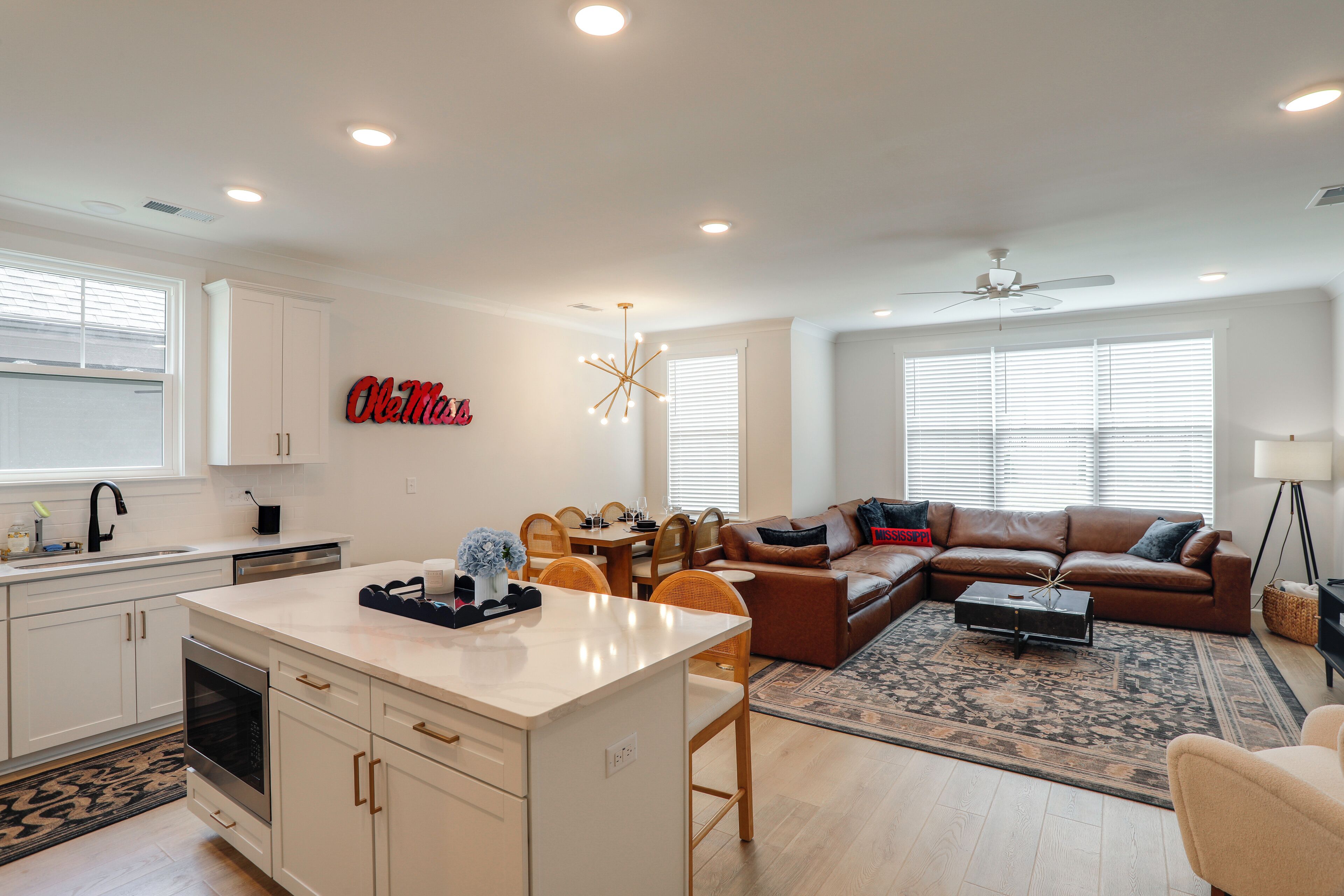 A modern living space with a kitchen, dining area, and a cozy seating area.
