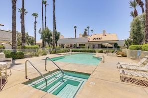 A swimming pool with steps, lounge chairs, and palm trees. - Relax Poolside! Golfer's Paradise in Palm Desert (Palm Desert)