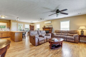 A spacious living area with a kitchen, dining area, and a ceiling fan. - Rural Bybee Retreat w/ Mtn Views! (Bybee)