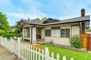 A two-story house with a white picket fence, a front porch, and a well-maintained lawn. - Steps to Main St! Restored Sonora Bungalow w/ Yard (Sonora)