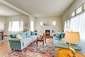 A living room with two sofas, a coffee table, and a fireplace.
