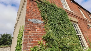 A brick building with a sign reading 'Old Vicage.' - Reighton House (Filey)