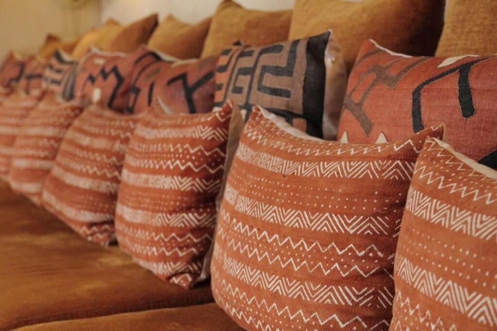 A row of patterned pillows on a couch.