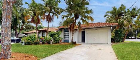 A residential property with a garage, a driveway, and a well-maintained lawn.