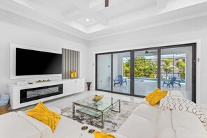 TV, offices - Luxe brand-new home with designer interior, lanai, private pool, & spa (Bonita Springs)