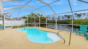 A covered swimming pool with a view of a body of water, surrounded by greenery and a white fence. - Waterfront & ground-floor home with free WiFi, dock, pool, & central AC (Englewood)