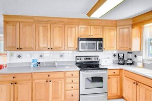 Fridge, microwave, oven, stovetop - Waterfront home with canal access, patio, sun room, & central AC - near beach (Englewood)