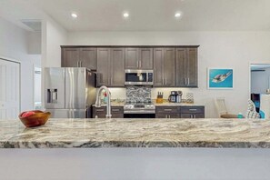Fridge, microwave, oven, stovetop - Spacious Canal-Front home with private pool, lanai, Game Room (Cape Coral)