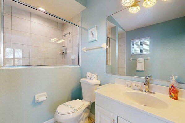 A bathroom with a toilet, sink, mirror, and shower. - Beautiful duplex with private W/D, WiFi, & close to the beach (Englewood)