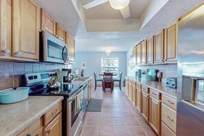 Fridge, microwave, oven, stovetop - Dog-friendly tropical home on the canal w/ screened patio w/ pool & private dock (Cape Coral)