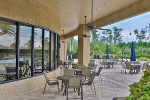 Outdoor dining - Spacious home with enclosed lanai, WiFi, AC, WD, pool, tennis court, & gym (Estero)