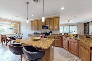 Fridge, microwave, oven, stovetop - Spacious home with enclosed lanai, WiFi, AC, WD, pool, tennis court, & gym (Estero)