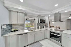 Fridge, microwave, oven, stovetop - Dog-friendly water-view house with pool & firepit - snowbirds welcome (Cape Coral)