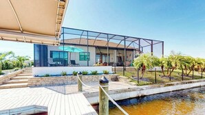 Une maison moderne dotée d’une piscine, d’une terrasse et d’un jardin clos.