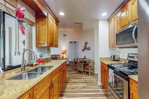 Fridge, microwave, oven, stovetop - Dog-friendly home with a private heated pool, screened lanai, W/D, & AC (Cape Coral)
