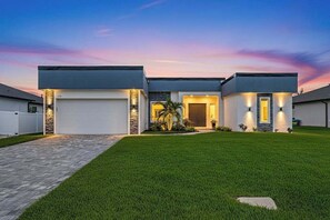 Exterior - Sophisticated and serene home on waterway, sparkling pool, fireplace, W/D & AC (Cape Coral)