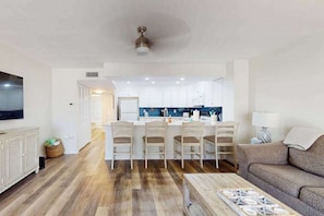 A modern apartment with a kitchen, dining area, and living room. - Beachfront condo with pool, private balcony, and washer and dryer (Englewood)
