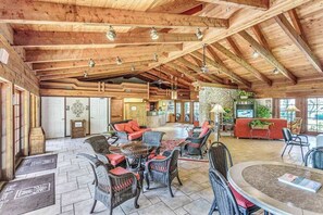A spacious lobby with high wooden ceilings, wicker furniture, and a stone accent wall. - Your Perfect Naples Retreat Relax at Park Shore Resort Snowbird Friendly (Naples)