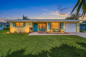 A single-story house with a front porch, a mailbox, and a well-maintained lawn. - Open-Air Waterfront Retreat | Private Pool (Cape Coral)