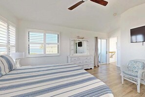A bedroom with a bed, a dresser, a chair, and a ceiling fan. - Beautiful duplex with private W/D, WiFi, & close to the beach (Englewood)