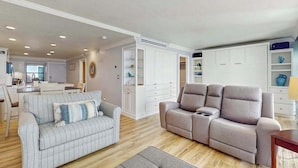 A living room with a grey sofa, a beige sofa, and a dining area with a table and chairs. - Waterview condo with shared pool, panoramic balcony views, and WIFI (Marco Island)