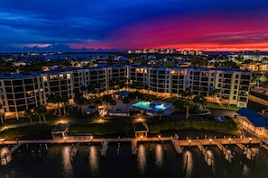 A hotel with multiple buildings, a swimming pool, and a dock area.