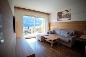 Classic Apartment, 1 Bedroom | Living area | 52-inch flat-screen TV with satellite channels, heated floors