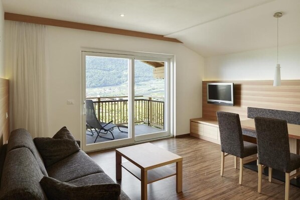 Family Apartment, 2 Bedrooms, Balcony, Mountain View | Living area | 52-inch flat-screen TV with satellite channels, heated floors
