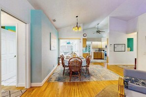 A dining area with a table and chairs, a kitchen in the background, and a ceiling fan. - Relax, Recharge & Explore. Your Waterfront Getaway Awaits. (Punta Gorda)