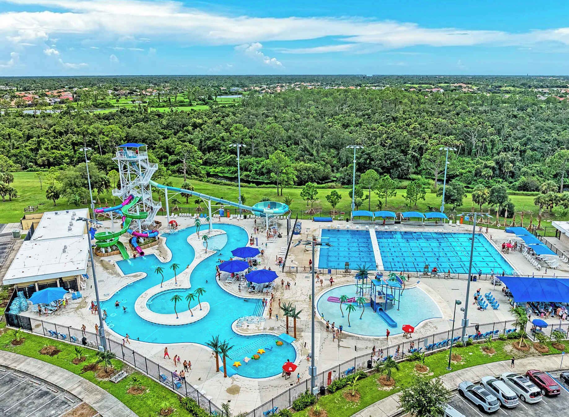 A water park with multiple pools, slides, and a large central pool.