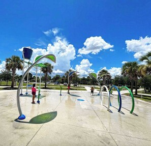 An outdoor water play area with multiple arches and a clear sky. - Sunny Snowbird Retreat with a Pool, Furnished Lanai, & Prime Corner Lot (Port Charlotte)