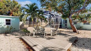 A patio with outdoor furniture, a covered seating area, and a tree. - Dog-friendly duplex with outdoor living - walk to beach & downtown (Venice)