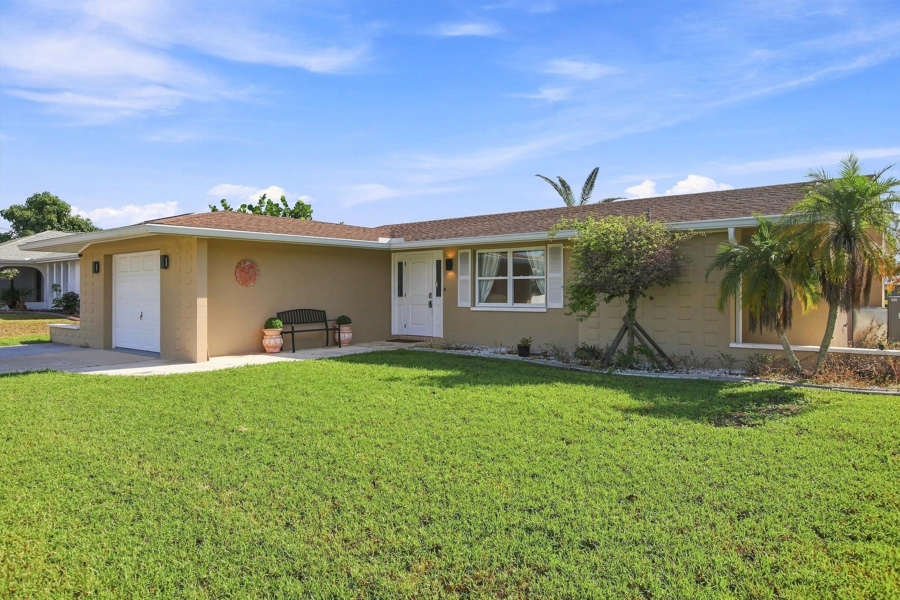 Inviting exterior with a spacious driveway providing convenient parking for up to three vehicles.