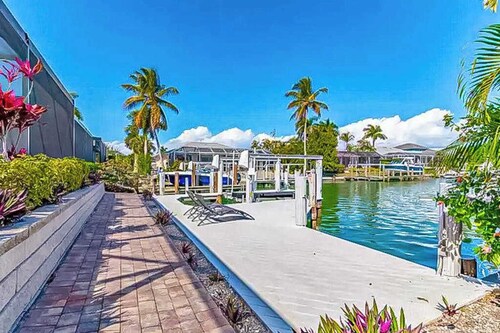 Canal-front home with private pool, pool spa, dock, boat access, grill, gym, W/D