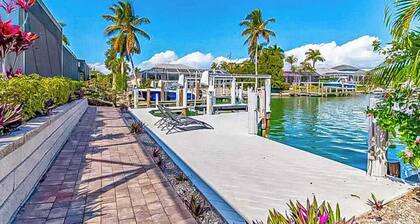 Canal-front home with private pool, pool spa, dock, boat access, grill, gym, W/D