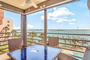Outdoor dining - Bayfront condo with shared pool, dock, & water views - snowbird-friendly (Marco Island)