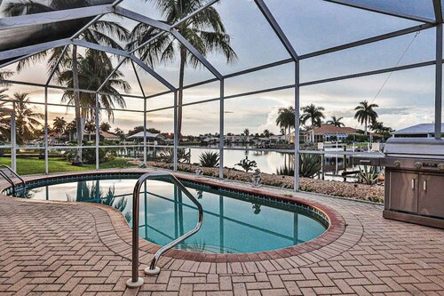 Upscale waterfront home with private dock, saltwater pool, lanai, grill, & W/D