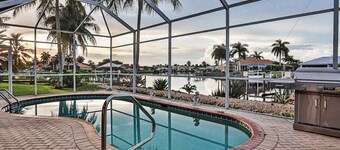Upscale waterfront home with private dock, saltwater pool, lanai, grill, & W/D