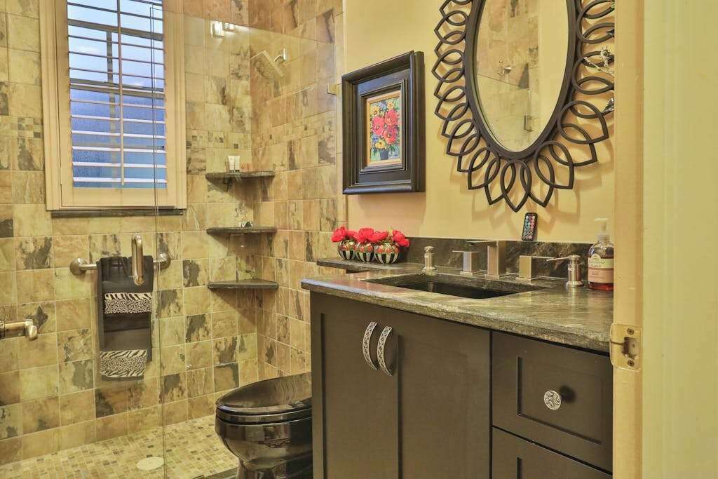 A bathroom with a bathtub, a sink, a toilet, and a vanity with drawers.
