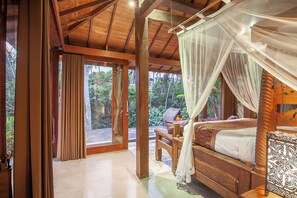 A wooden room with a bed, a bench, and a view of the outdoors. - private 4-bedroom villa with Infinity pool in peaceful Ubud (ubud)
