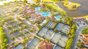 An aerial view of a resort with multiple swimming pools, tennis courts, and a golf course. - Deluxe home in a resort community with amazing views, pool, & hot tub (Naples)
