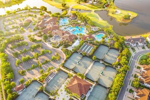 An aerial view of a resort with multiple swimming pools, tennis courts, and a golf course. - Deluxe home in a resort community with amazing views, pool, & hot tub (Naples)