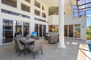 Outdoor dining - Exquisite waterfront home with lanai, heated pool and spa(hot tub), and internet (Naples)