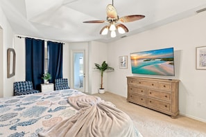 A bedroom with a bed, a dresser, a TV, and a ceiling fan. - Waterfront Paradise with Private Pool, Game Room (Punta Gorda)