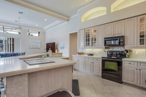 Fridge, microwave, oven, stovetop - Waterfront home with saltwater pool, pool spa, central AC, W/D, & office space (Marco Island)