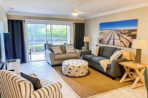 TV, offices - Lakefront getaway with walk-out lanai, pool, tennis/Bocce courts & marina (North Naples)